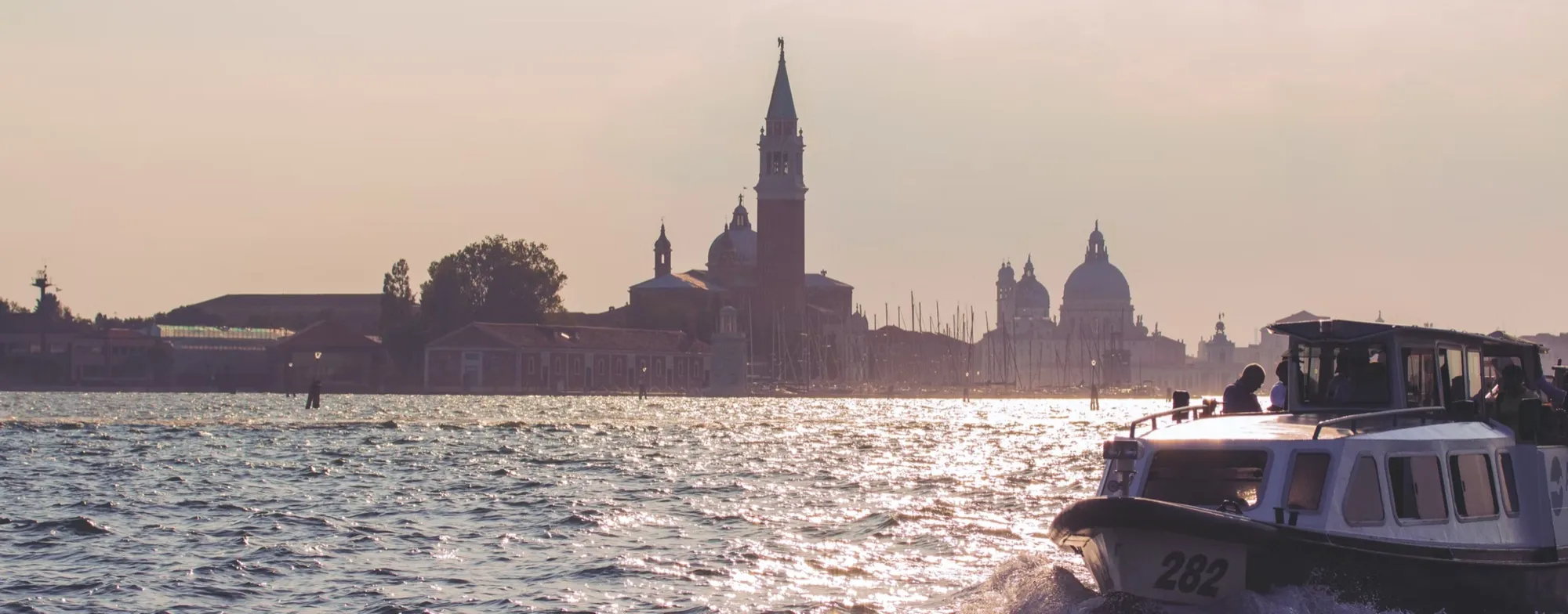 Venice at dusk, a vaporetto crossing the lagoon